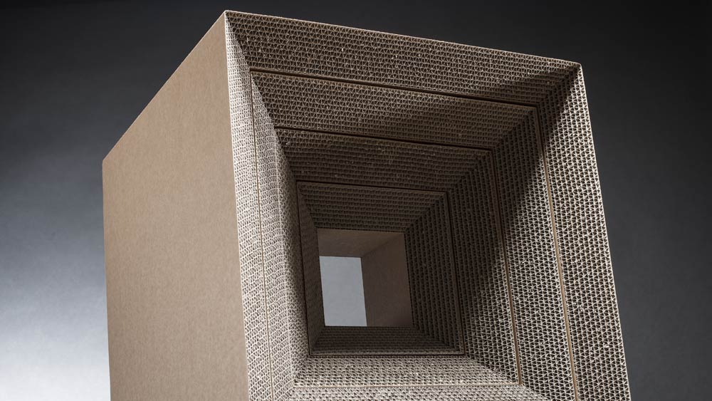 KAOX shelf and stool system made of corrugated cardboard with 45° slanted edges which reveal the weavy interior